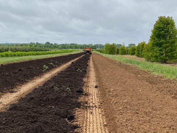 compost spreader in nursery field