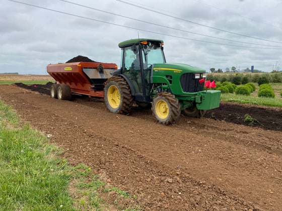 compost spreader in nursery field