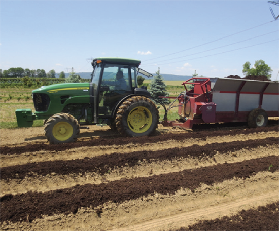 tractor-spreads-compost-at-field-production-nursery